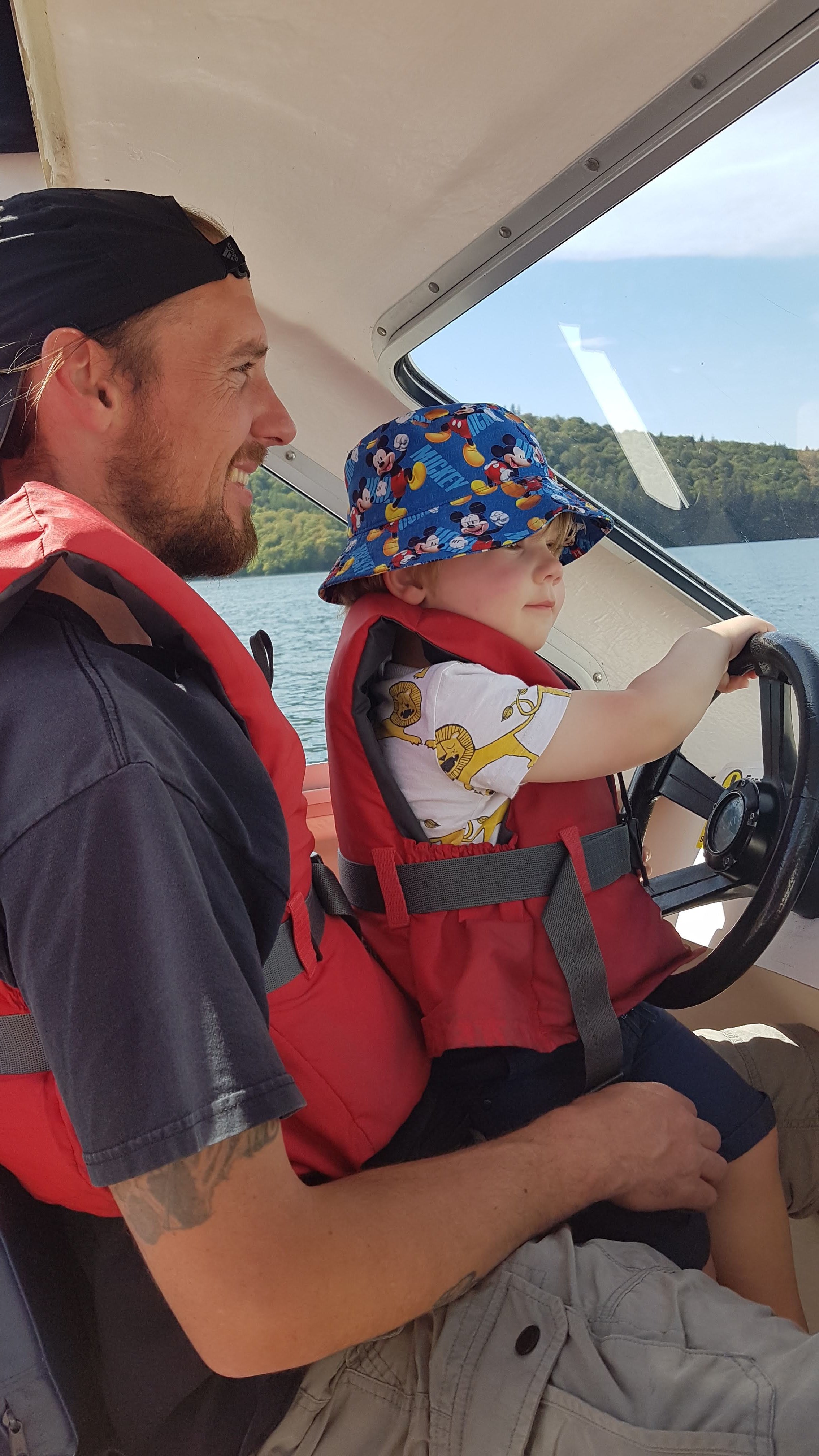 Toddler driving a boat